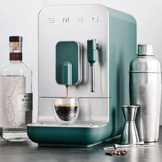 an espresso machine is being used to make coffee and other drinks on the table