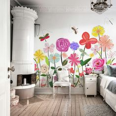 a bedroom with flowers painted on the wall