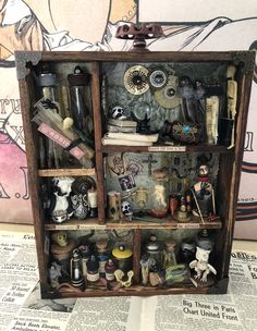 an open book shelf filled with assorted items and knick - knacks