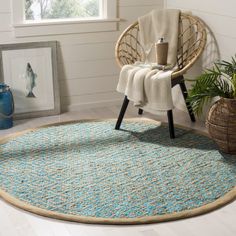 a round rug in the corner of a room with a chair and potted plant