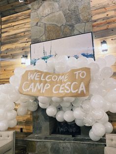 there is a welcome to camp cesa sign in the middle of this room with balloons