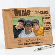 a personalized wooden frame with an image of two boys and one is holding a pen