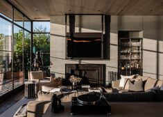 a living room filled with furniture and lots of windows