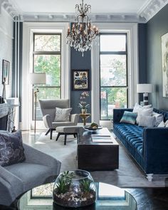 a living room filled with furniture and a chandelier