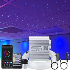 some lights and remote controls in a room with blue lighting on the ceiling above them