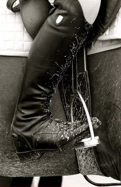 black and white photo of woman's legs in boots