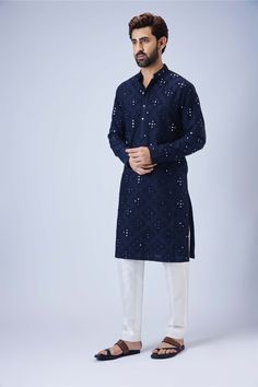 Editor's Note Introducing a navy blue mirror kurta adorned with exquisite dori work ojis, paired elegantly with a comfortable pant pyjama. The navy blue hue exudes sophistication, while the mirror work and dori detailing add a touch of opulence. The kurta's intricate craftsmanship is perfectly complemented by the tailored pant pyjama, ensuring both style and comfort. This ensemble is ideal for special occasions or cultural celebrations. Fabric: Cotton silk Color: Navy blue Components: Kurta and Indigo Chikankari Kurta For Navratri, Indigo Chikankari Embroidery Kurta For Navratri, Indigo Dabka Straight Kurta, Indigo Straight Kurta With Dabka, Indigo Kurta For Navratri, Indigo Kurta For Navratri Festive Season, Indigo Festive Kurta For Navratri, Festive Indigo Kurta For Navratri, Designer Blue Sherwani With Gota Work