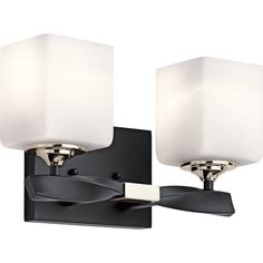 two light bathroom fixture with white glass shades on the wall and black metal frame,