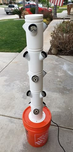 a white and red fire hydrant sitting on the side of a road