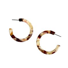 These acrylic hoop earrings, made from a rich mix of brown and cream hand-swirled acrylic, are the perfect versatile accessory to complete any look.  Due to the handmade, manual process, slight variations in the product, including color and finish, are expected. These earrings were specially curated for Closet Rehab. Please check out our entire collection. Materials: acrylic, stainless steel posts Hypoallergenic  Our accessories are handcrafted from colorful acrylic. To preserve your Closet Rehab products, we recommend storing safely in our pouches. Avoid contact with harsh substances like perfumes and hairsprays. Items with plated metals naturally tarnish over time when exposed to body oils and other natural elements. Please handle with care, as excessive dropping, wear and tear, and impr Acrylic Hoop Earrings, Clothing Optional, September Birthstone Jewelry, Body Oils, August Birthstone Jewelry, July Birthstone Jewelry, Zodiac Jewelry, Acrylic Jewellery, Gifts For New Mums