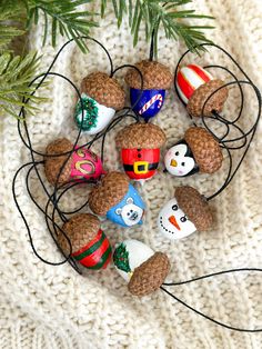 a knitted blanket with pine cones and christmas decorations