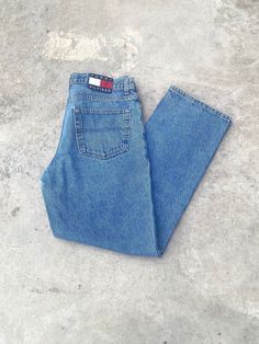 Vintage 1990s Tommy Hilfiger Blue Jeans - Size 34W x 32L - Outseam 42" Inseam 31.5" - Great vintage condition (small stain pictured) - Message for more information Please take note of the measurements listed as these are vintage clothes and may fit different than the tag size. Follow our page for more vintage clothing drops! DISCLAIMER: All items are vintage so please be mindful that if by chance there is a flaw on the item we simply may have just missed it. Inquire for more product information. 90s Style Blue Jeans, 90s Style Denim Blue Jeans, 90s Inspired Medium Wash Cotton Jeans, 90s Inspired Medium Wash Jeans With Pockets, 90s Denim Blue Jeans With Five Pockets, 90s Tommy Hilfiger, Denim Wide Leg, Jean Large, Baggy Denim