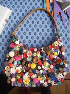 a handbag made out of buttons on a table