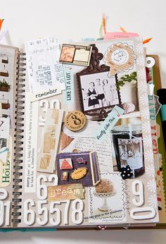 an open notebook with many different things on it, including scissors and other crafting supplies