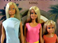 three barbie dolls standing next to each other in front of a sign that says tropical escape