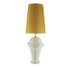 a white lamp with a gold shade on it