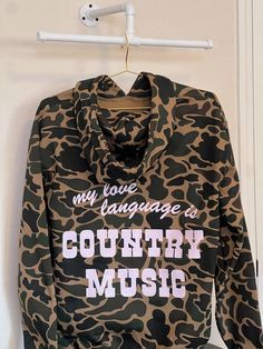 Unisex heavy duty duck camo hoodie detailed with our "My Love Language is Country Music" design in light pink! Features: - 10 oz., 80% cotton/20% polyester fleece - Premium soft heavyweight fabric and generous fit - Fleece lined hood with heavy gauge round drawcord and nickel eyelets - Twill neck tape - Front pouch pocket - 1x1 rib knit cuffs and waistband - Double-needle stitched throughout. HOME CARE/WASHING INSTRUCTIONS: - Turn inside out when washing/drying. Wash cold and dry on normal temp. Please reach out if you have any questions! Sizing: (Please see listing images for size chart!) Southern Outfits, Showing Livestock, Outwear Fashion, My Love Language, Cute Country Outfits, Country Quotes, Camo Hoodie, Cute N Country, Love Language