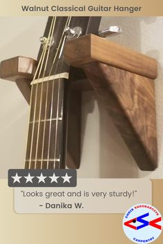 an acoustic guitar hanging on the wall