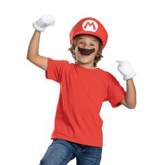 a young boy wearing a mario costume and holding his arms up in the air with both hands