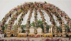 an outdoor wedding setup with chairs and flowers