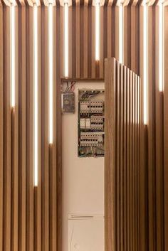 a white refrigerator freezer sitting inside of a wooden kitchen wall covered in magnets