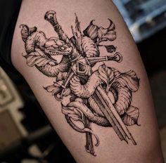 a black and white photo of a tattoo on someone's arm with an arrow in the middle