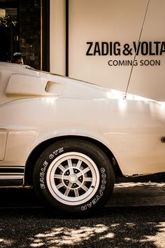 a white car parked in front of a building