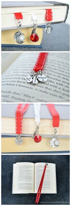 the bookmarks are attached to an open book with red ribbon and charms on them