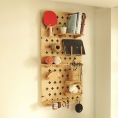 a wall mounted shelf with various items on it