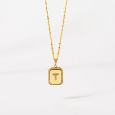 Timeless, elegant, and classy - our gold initial pendant necklace gives a personal touch to any outfit. This 18-20" personalized necklace features a gold pendant with an initial that is framed by shimmering crystals and the empowering message “I am Beautiful, Resilient, Strong, Enough, Loved ”is delicately engraved on the back. Tough days don't stand a chance against your inner fire! Wear this gold initial necklace to remind yourself that you are beautiful, loved, enough, strong, and resilient t Tan Monogram Initial Pendant Necklace, Tan Initial Pendant Necklace, Elegant Initial Pendant Necklace With Letter Beads, Elegant Personalized Tan Initial Necklace, Elegant Gold Letter Bead Necklaces, Gold Monogram Initial Pendant Necklace, Gold Elegant Necklaces With Letter Beads, Elegant Gold Necklaces With Letter Beads, Gold Initial Pendant Name Necklace