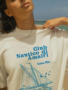 Set sail with our "Amalfi Nautical Club" Tee! ⚓ This vintage-inspired graphic T-shirt captures the essence of coastal living, perfect for maritime enthusiasts and beach lovers. Crafted from soft, breathable cotton, it offers both comfort and style for any occasion. Add a touch of seaside charm to your wardrobe with this elegant tee! Details: Material: 100% Cotton Sizes: XS, S, M, L, XL, XXL Care: Machine wash cold, tumble dry low Designed with love and crafted for comfort ❤️ Tags: amalfi nautica Vintage Nautical, Casual Summer Tops, Tee Shirt Designs, Beach Lovers, Coastal Style, Summer Top, Amalfi, Vintage Tees, Vintage Tshirts