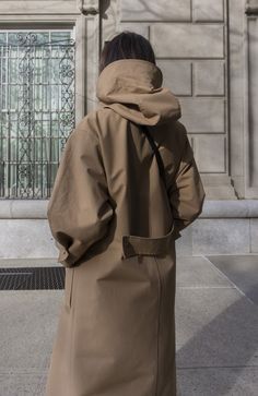 Fabric: 73% Cotton, 27% NylonColor: Light BrownCare: Hand wash / Dry clean Waterproof oversized hooded trench coat with two front pockets and centre front bottom closure. The length is 46-47 inches (118-120 cm). Unlined. Consider wearing at a temperature 68-50°F (20-10°C) Made in USA. Yellow Parka, Pijamas Women, Khaki Trench, Khaki Trench Coat, Hooded Trench Coat, Statement Coat, Hooded Raincoat, Trench Coat Black, Oversized Coat