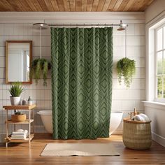 a bathroom with a green shower curtain next to a white bath tub and wooden floors