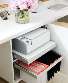 a white desk with drawers and printer on it