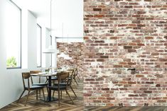 a brick wall in an empty room with chairs and tables