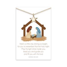 a christmas card with a nativity scene and a star hanging from the top of it