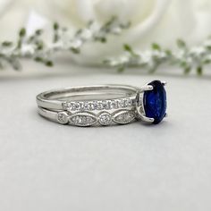 This beautiful ring is made from genuine 925 sterling silver with rhodium plating. Ring details- -The Main stone is an oval cut 8mm by 6mm Lab Created Blue Sapphire Stone -Side stones are 1.2 Round simulated diamonds -Ring is casted in solid 925 sterling silver with rhodium plating (yellow gold and rose gold plated also available, please check the drop down menu for more options) -The Total face height of the ring measures 8mms and the band width measures 2mms -Each ring is handmade and made to Oval Cubic Zirconia Stackable Rings In Fine Jewelry Style, Oval Cubic Zirconia Stackable Rings, Stackable Rings With Diamond Accents For Gifts, Oval Cubic Zirconia Stackable Rings With Prong Setting, Silver Oval Stackable Promise Rings, Oval Stackable Rings With Diamond Accents For Promise, Oval Stackable Rings In White Gold And Sterling Silver, Oval Stackable Promise Rings With Accent Stones, Oval Cubic Zirconia Stackable Rings For Gift