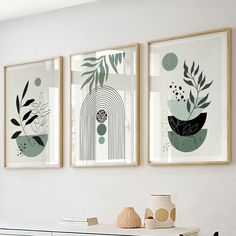 three framed art prints on the wall above a dresser