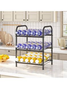 three tiered rack with blue and yellow plates on it in the middle of a kitchen