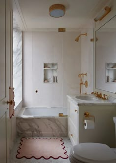 a bathroom with a toilet, sink and bathtub