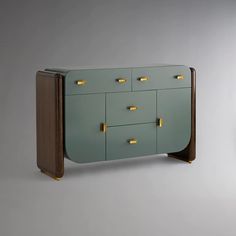 a green cabinet with gold handles and drawers on the front, against a gray background