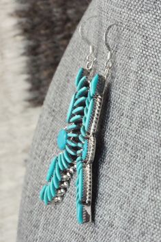 These turquoise and sterling silver earrings were made by Zuni silversmith Edmund Cooeyate. The backs are signed Ed . C. and stamped .925Length: 2 3/8"Width: 5/8"Free shipping on all orders! We ship with USPS and always include tracking. All orders ship within a day of payment.Returns are accepted up to 30 days after you receive your order. Just send us a message. Our shop offers cash back or store credit. The item must be returned in new condition. Turquoise Concho Dangle Jewelry, Nickel-free Turquoise Southwestern Earrings, Turquoise Nickel-free Southwestern Earrings, Adjustable Turquoise Concho Earrings, Blue Concho Dangle Earrings, Native American Jewelry, Turquoise Sterling Silver, Free Jewelry, Sterling Silver Earrings