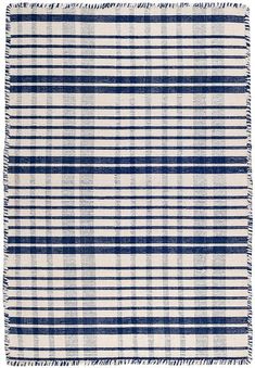 a blue and white plaid rug with fringes