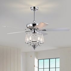 a ceiling fan with crystal chandelier hanging from it's blades in a living room