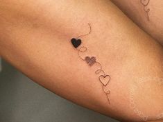 a couple of tattoos that are on the legs of someone's leg and one has a heart in it