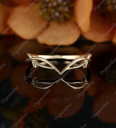 a close up view of a ring with flowers in the background