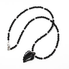 Make a statement with this bold and beautiful black onyx necklace! Featuring a hand carved onyx leaf, glimmering sterling silver beads and natural onyx and sterling silver beads that catches the light, it's sure to become your favorite accessory. Adding a touch of nature-inspired elegance to your jewelry collection, this unique and special piece is sure to make heads turn. Will you make it yours? Genuine 3mm Black Onyx BeadsHand Carved Black Onyx Pendant about 11/16" W x 1" L925 Sterling Silver Luxury Carved Black Jewelry, Luxury Single Strand Onyx Jewelry, Luxury Onyx Necklace With Polished Finish, Black And Silver Jewelry, Black Onyx Necklace, Onyx Necklace, Bold And Beautiful, Onyx Bead, Amazon Handmade