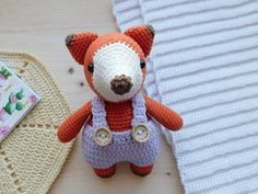 a small stuffed animal is next to a crocheted baby bib and pacifier