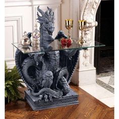 a glass table topped with a dragon statue