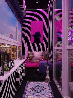 the room is decorated in black, white and pink with zebra print on the walls